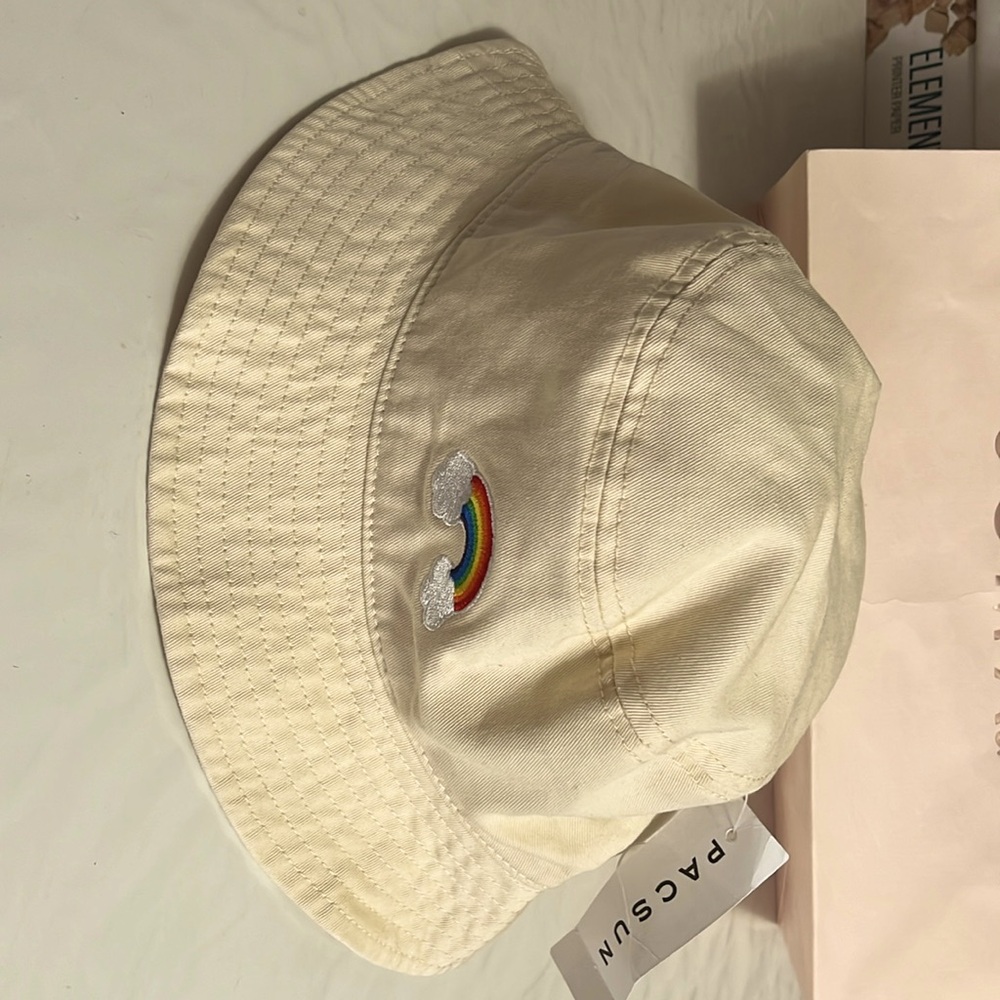 brand new a cream-colored Pacsun bucket hat with a rainbow embroidered in front